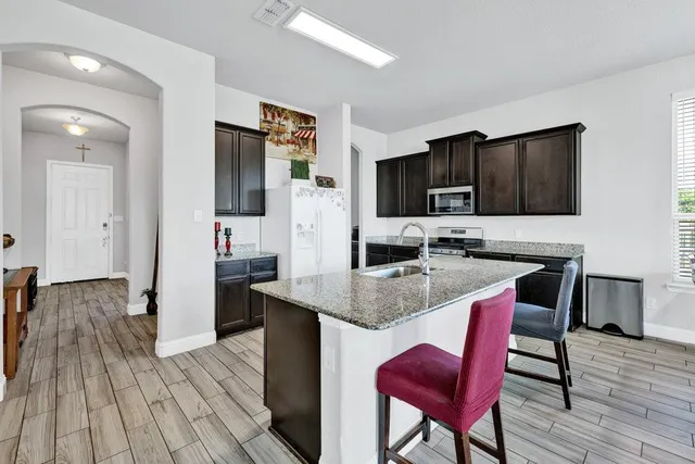a kitchen with stainless steel appliances granite countertop a sink stove and oven