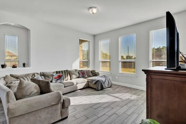 a kitchen with a table chairs and wooden floor