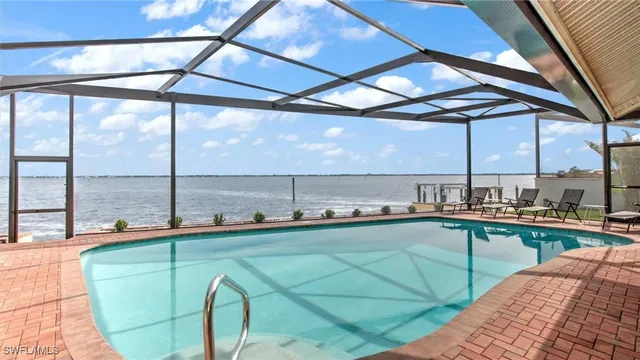 a view of a swimming pool and outdoor seating