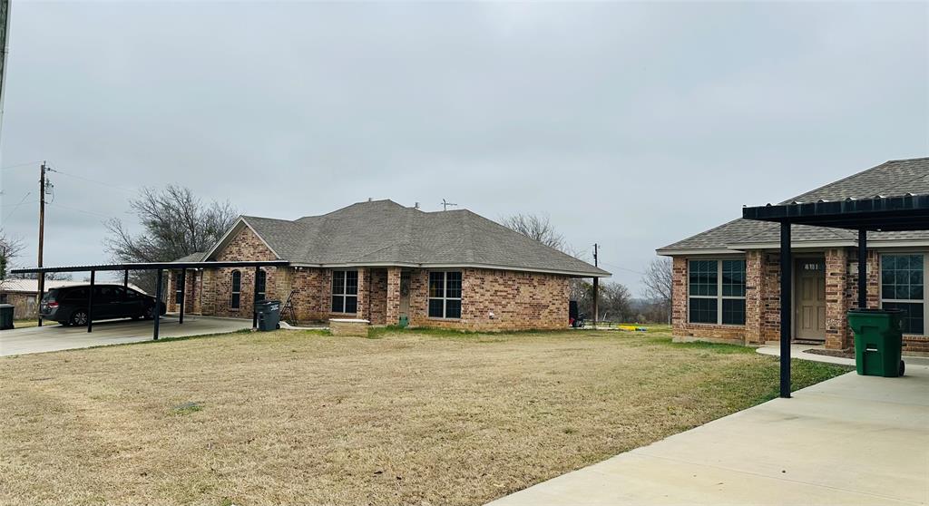 399 Erwin Road, Unit 393 395 397 399 Poolville, TX 76487 - Photo 4 of 6 front view of a house with a yard