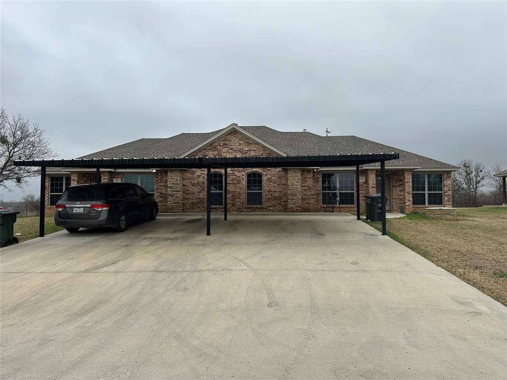 399 Erwin Road, Unit 393 395 397 399 Poolville, TX 76487 - Photo 5 of 6 a house view with a garden space