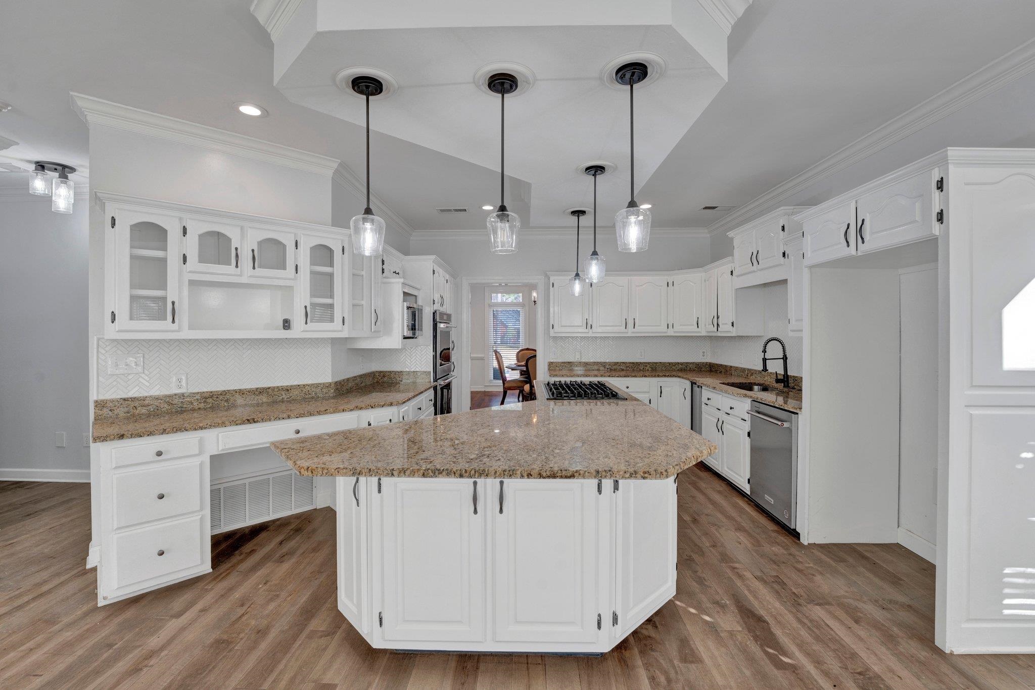 47 Summer Grove Road Memphis, TN 38018 - Photo 10 of 35 Kitchen featuring stainless steel appliances, a kitchen island, white cabinets, and crown molding