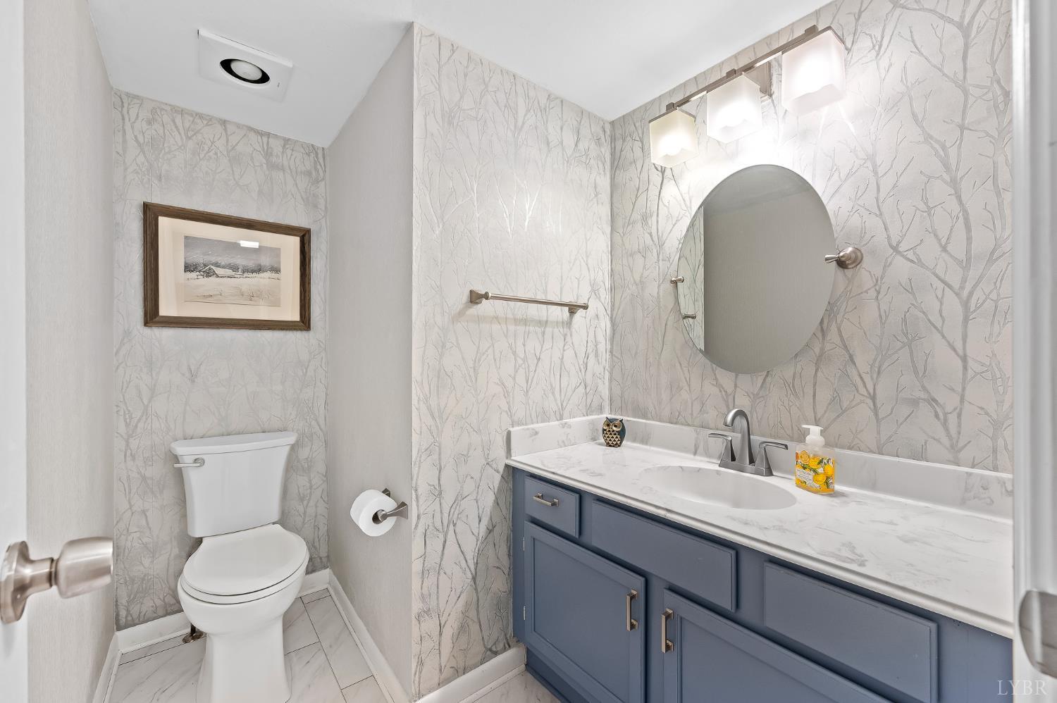 174 Sunset Ridge Road Forest, VA 24551 - Photo 14 of 43 a bathroom with a toilet sink and mirror
