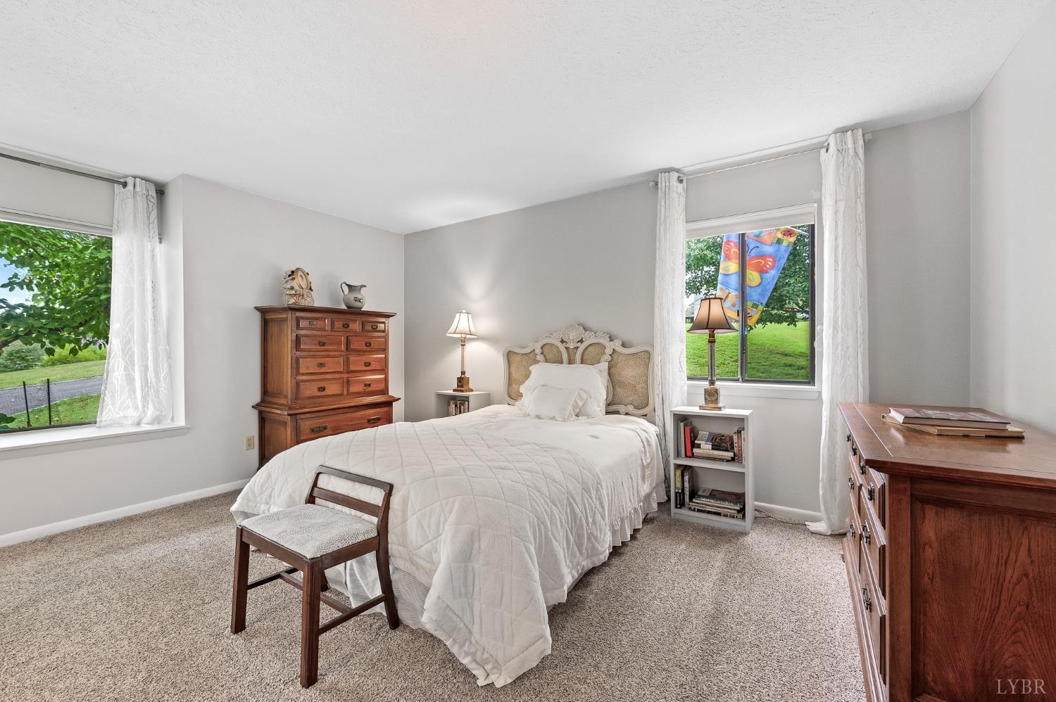 174 Sunset Ridge Road Forest, VA 24551 - Photo 15 of 43 a bedroom with a bed next to a window and a flat screen tv