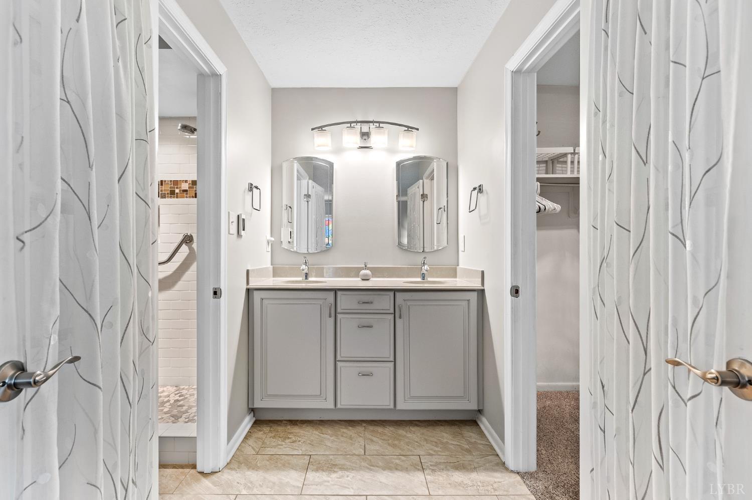 174 Sunset Ridge Road Forest, VA 24551 - Photo 18 of 43 a bathroom with a double vanity sink and mirror