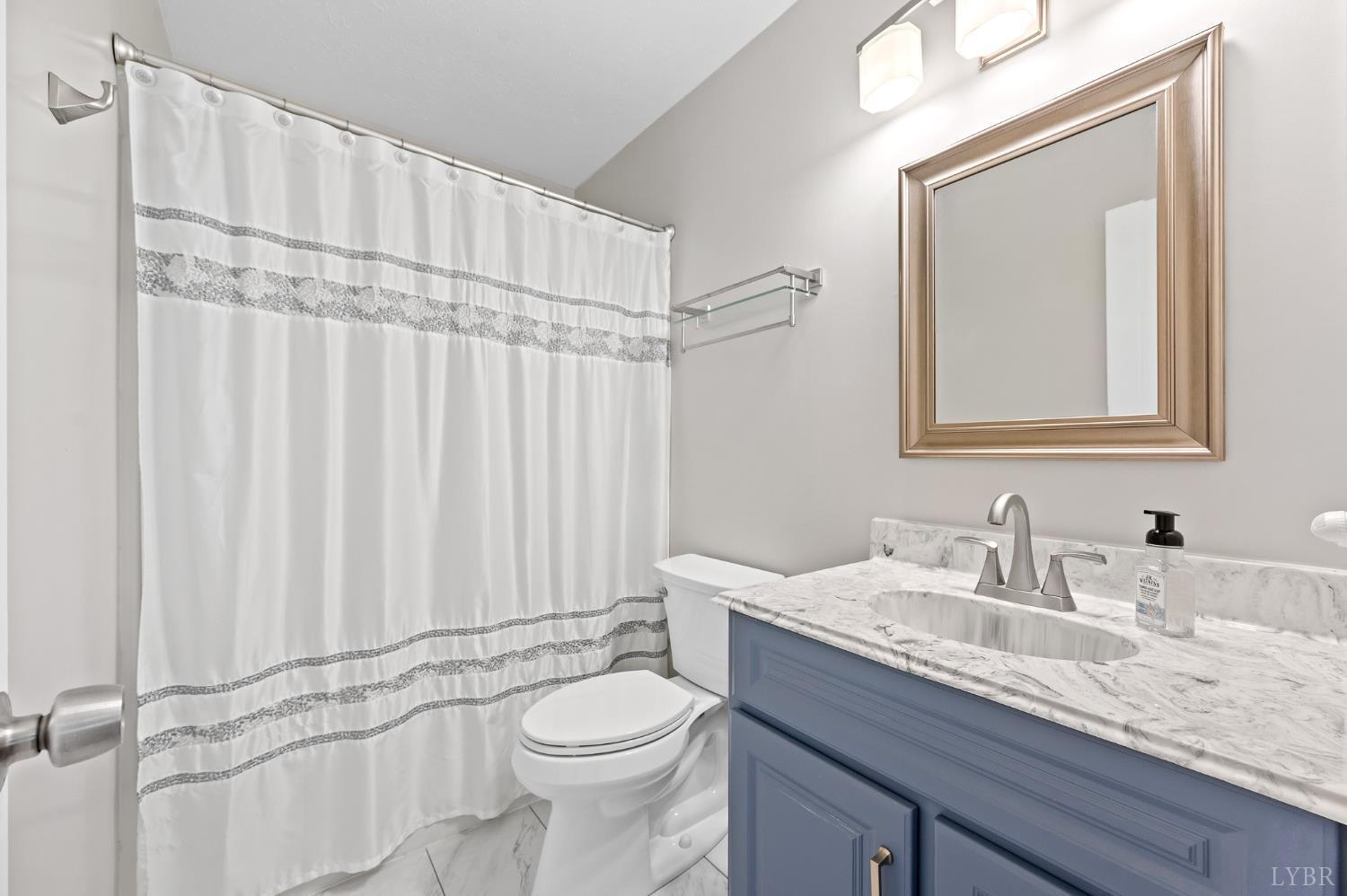 174 Sunset Ridge Road Forest, VA 24551 - Photo 26 of 43 a bathroom with a granite countertop sink a toilet and a mirror
