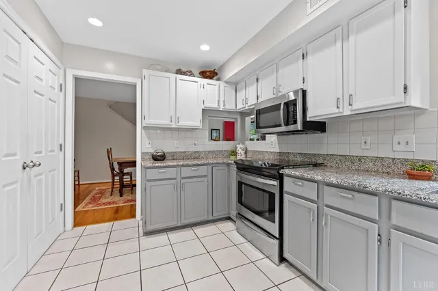 a kitchen with stainless steel appliances granite countertop a sink and cabinets