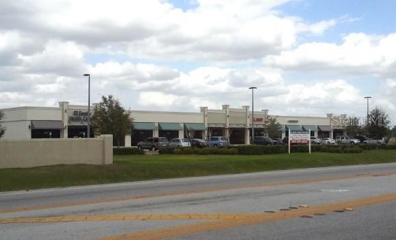 a view of a city with a big yard and a large trees