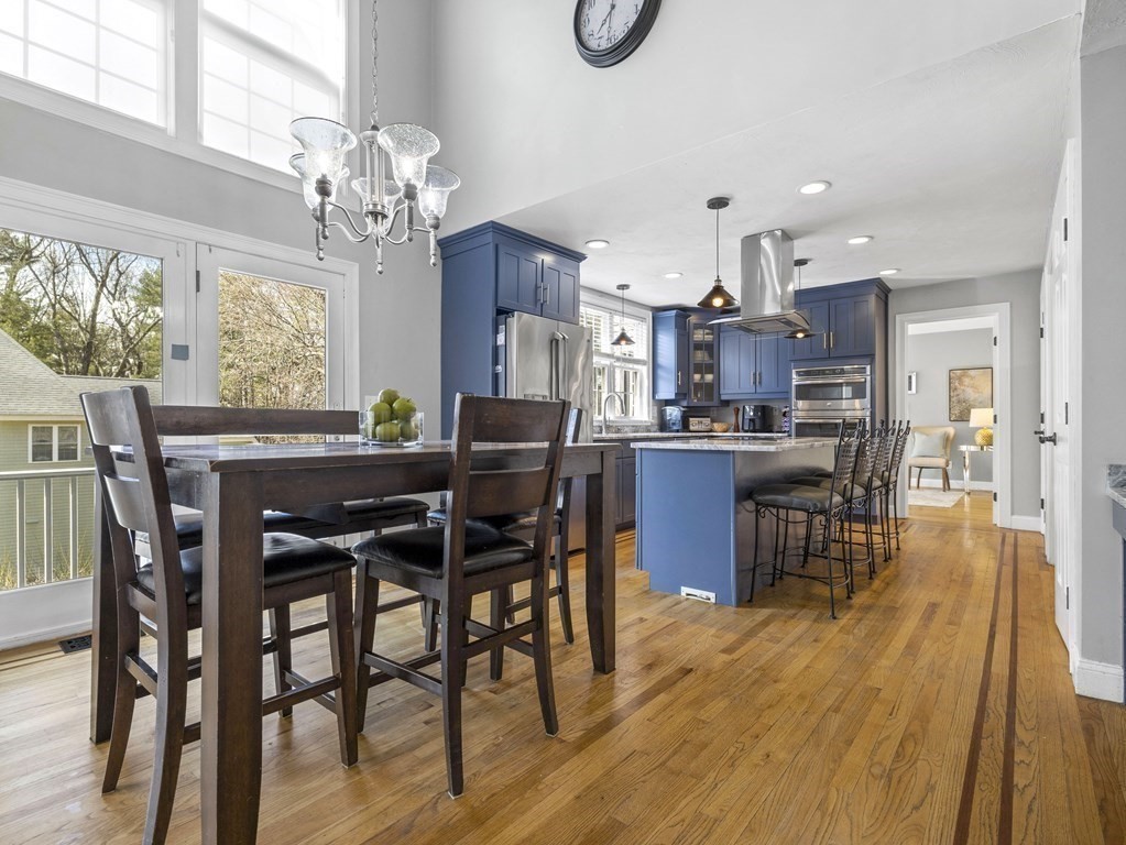 23 Vesta Road Natick, MA 01760 - Photo 11 of 30 a view of a dining room with furniture a chandelier and wooden floor