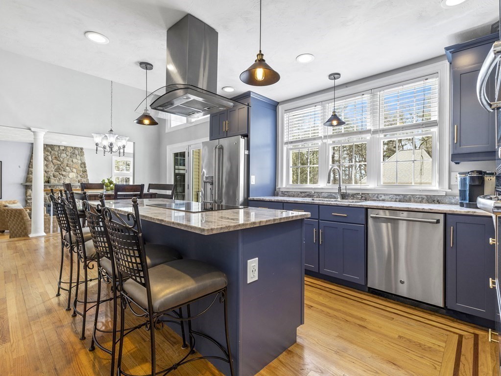 23 Vesta Road Natick, MA 01760 - Photo 13 of 30 a kitchen with stainless steel appliances granite countertop table chairs and a large window