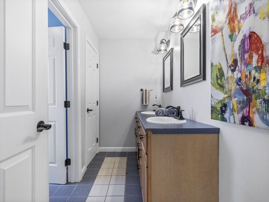 23 Vesta Road Natick, MA 01760 - Photo 24 of 30 a bathroom with a sink a mirror and shower