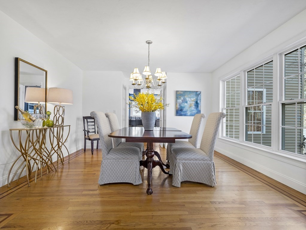 23 Vesta Road Natick, MA 01760 - Photo 6 of 30 a view of dining room and livingroom with furniture wooden floor a rug a potted plant and a chandelier