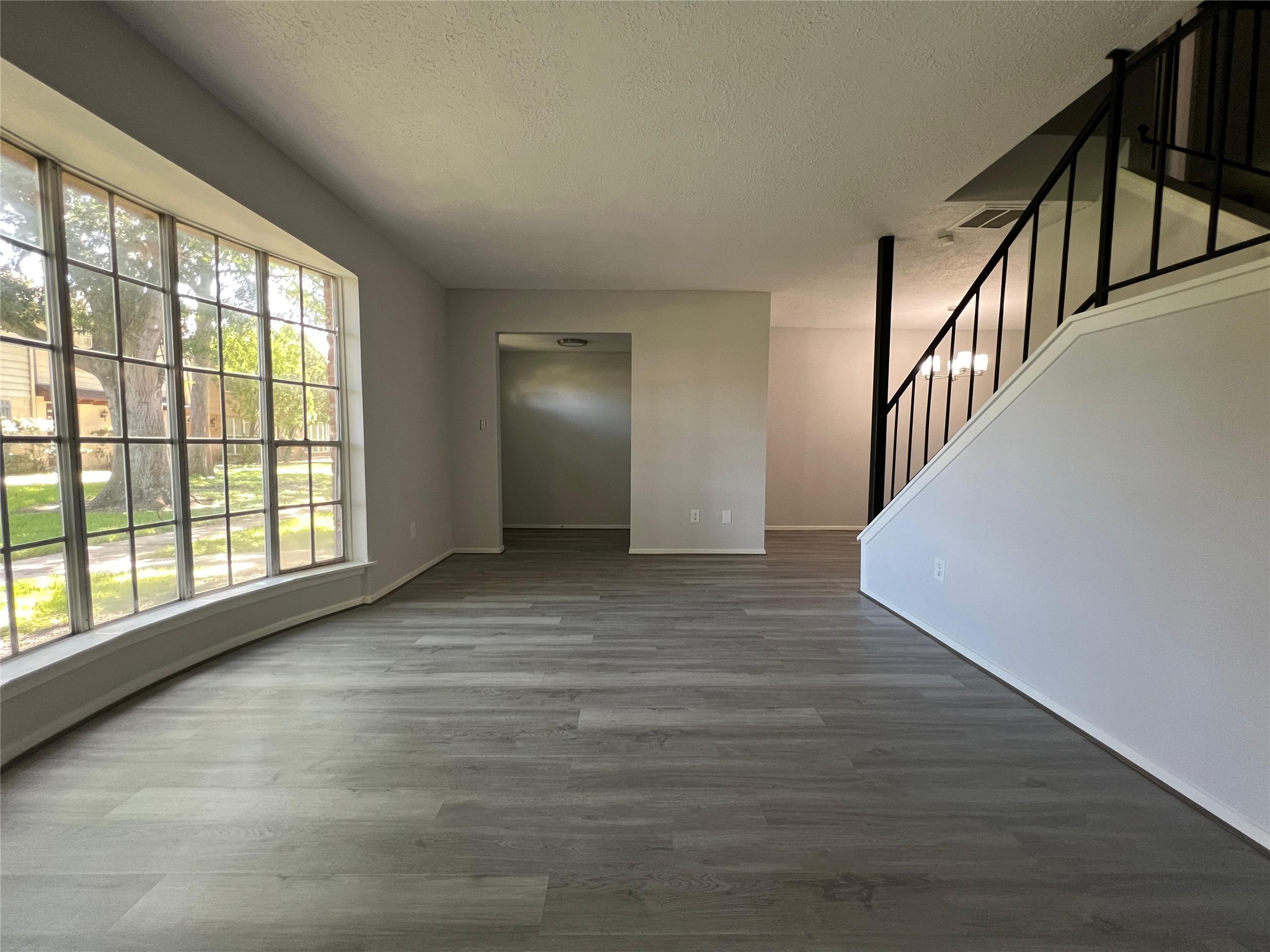 7012 Jetty Lane Houston, TX 77072 - Photo 2 of 24 a view of an empty room with wooden floor and a window