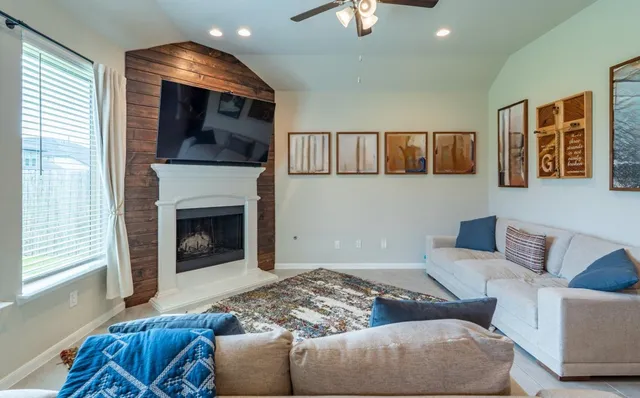 a spacious bathroom with a granite countertop sink a bathtub and window
