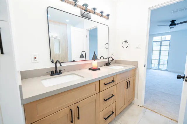 a bathroom with a double vanity sink and a mirror
