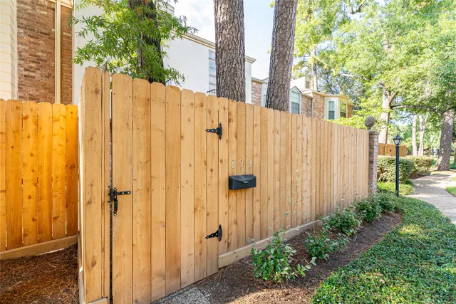 a view of a house with backyard and trees