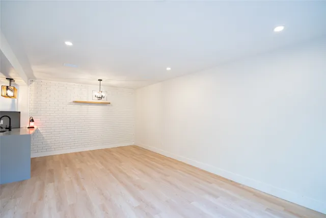 a view of a room with wooden floor and white walls