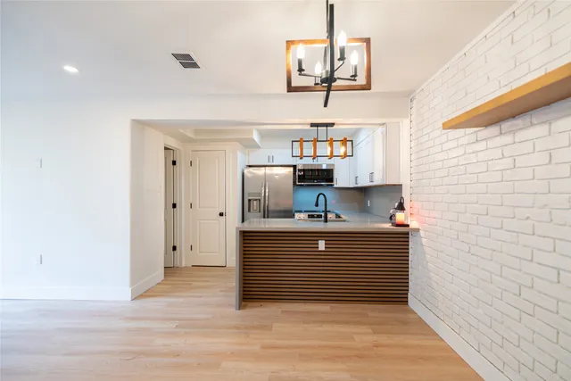 a kitchen with stainless steel appliances a stove and cabinets