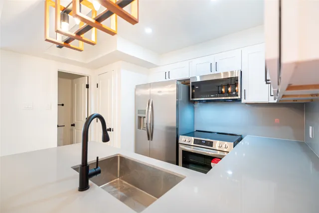 a kitchen with stainless steel appliances a stove and a refrigerator