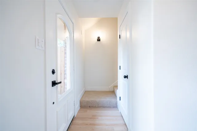 a view of a hallway with wooden floor