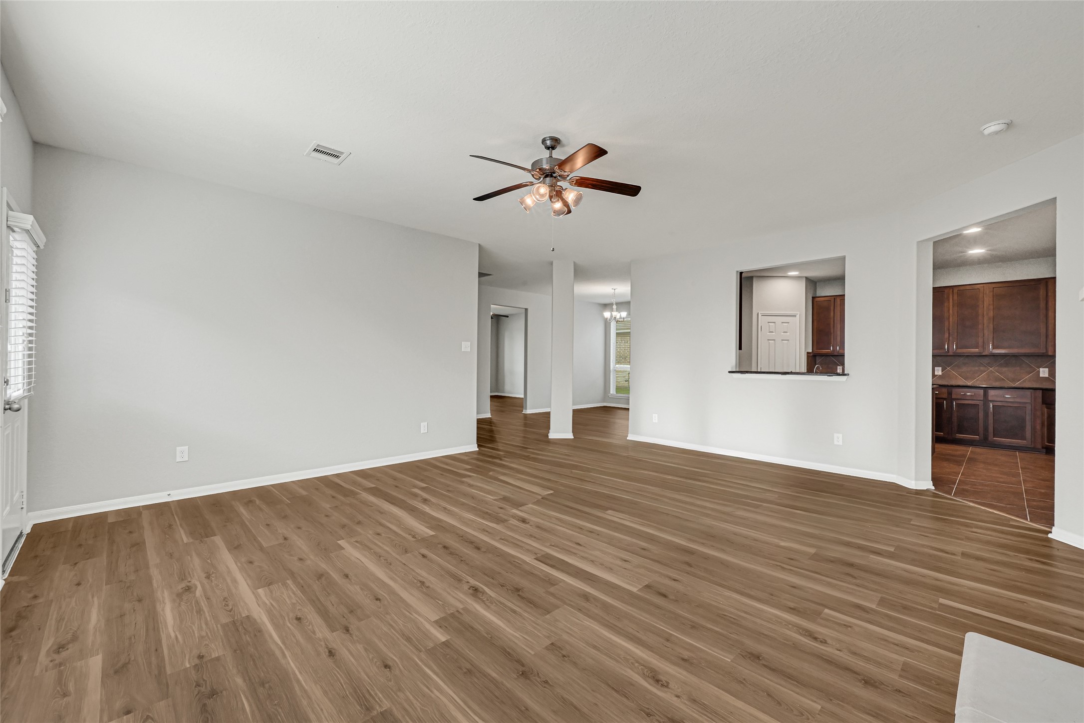 5331 Seabird Street Baytown, TX 77521 - Photo 14 of 38 a view of empty room with wooden floor and ceiling fan