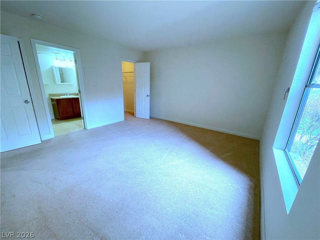 3135 South Mojave Road, Unit 156 Las Vegas, NV 89121 - Photo 8 of 18 A well-lit bedroom features plush carpeting and convenient access to a private bathroom and walk-in closet.
