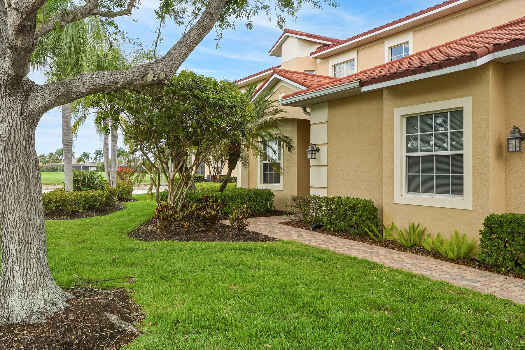 8605 Champions Point, Unit 103 Naples, FL 34113 - Photo 38 of 44 a front view of a house with garden