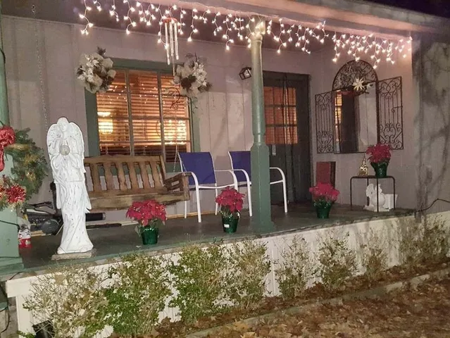 a bedroom with furniture and chandelier