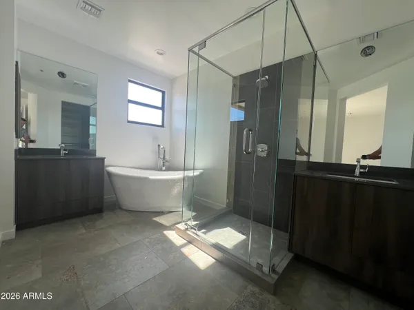 a bathroom with a double vanity sink and mirror