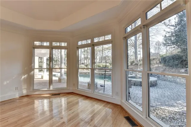 a living room with a fireplace and a floor to ceiling window