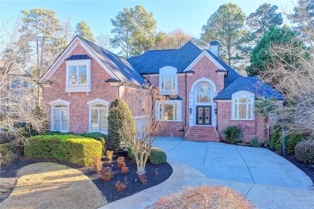 a front view of a house with a yard and outdoor seating