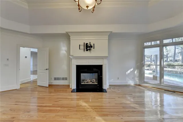 a bathroom with a double vanity sink a large mirror and a bathtub