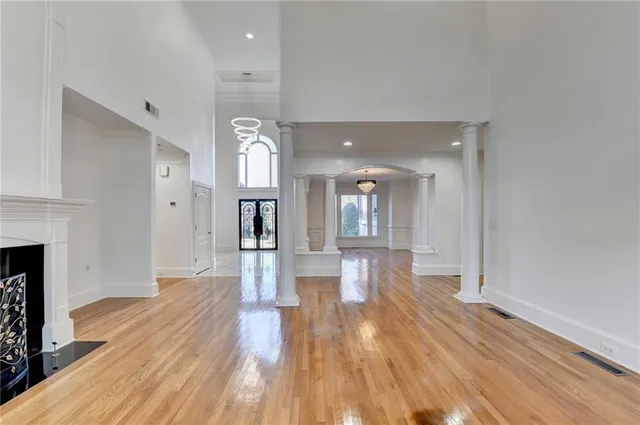 a view of a livingroom with wooden floor and a fireplace