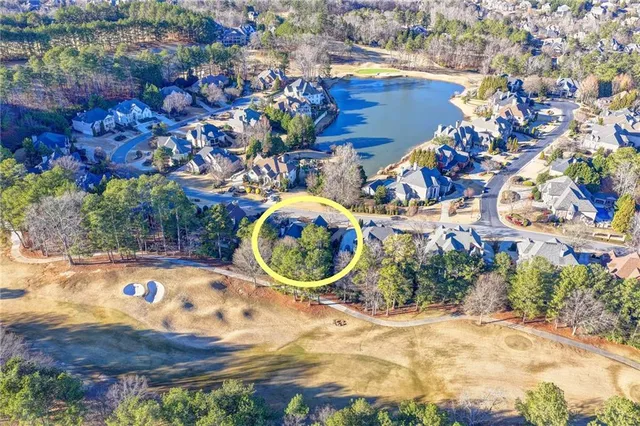 an aerial view of a house with a yard