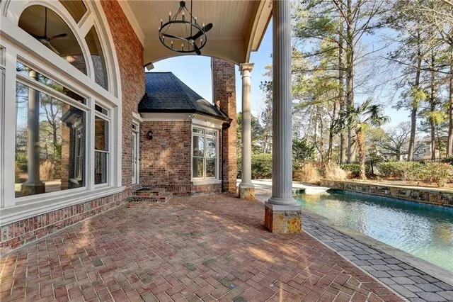 a view of a swimming pool with a patio