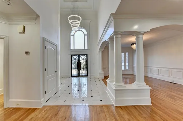 a view of an entryway with wooden floor and a fireplace