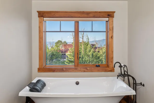 a bath tub sitting next to a window