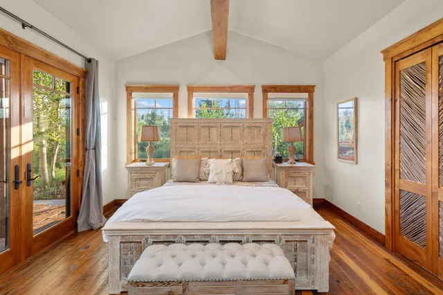 a bed sitting in a bedroom next to a window