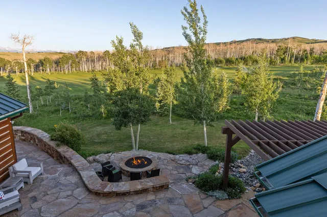 a view of a backyard with sitting area