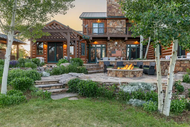 a view of a house with sitting area and a garden