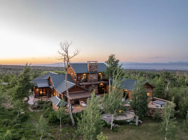 an aerial view of a house with a yard and lake view