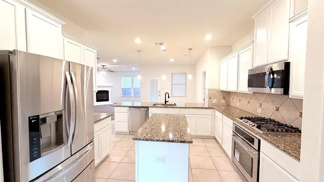 a bathroom with a granite countertop sink a toilet and mirror