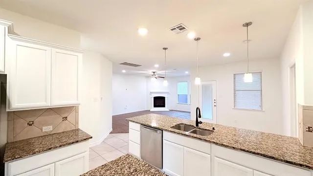 a kitchen with sink and refrigerator