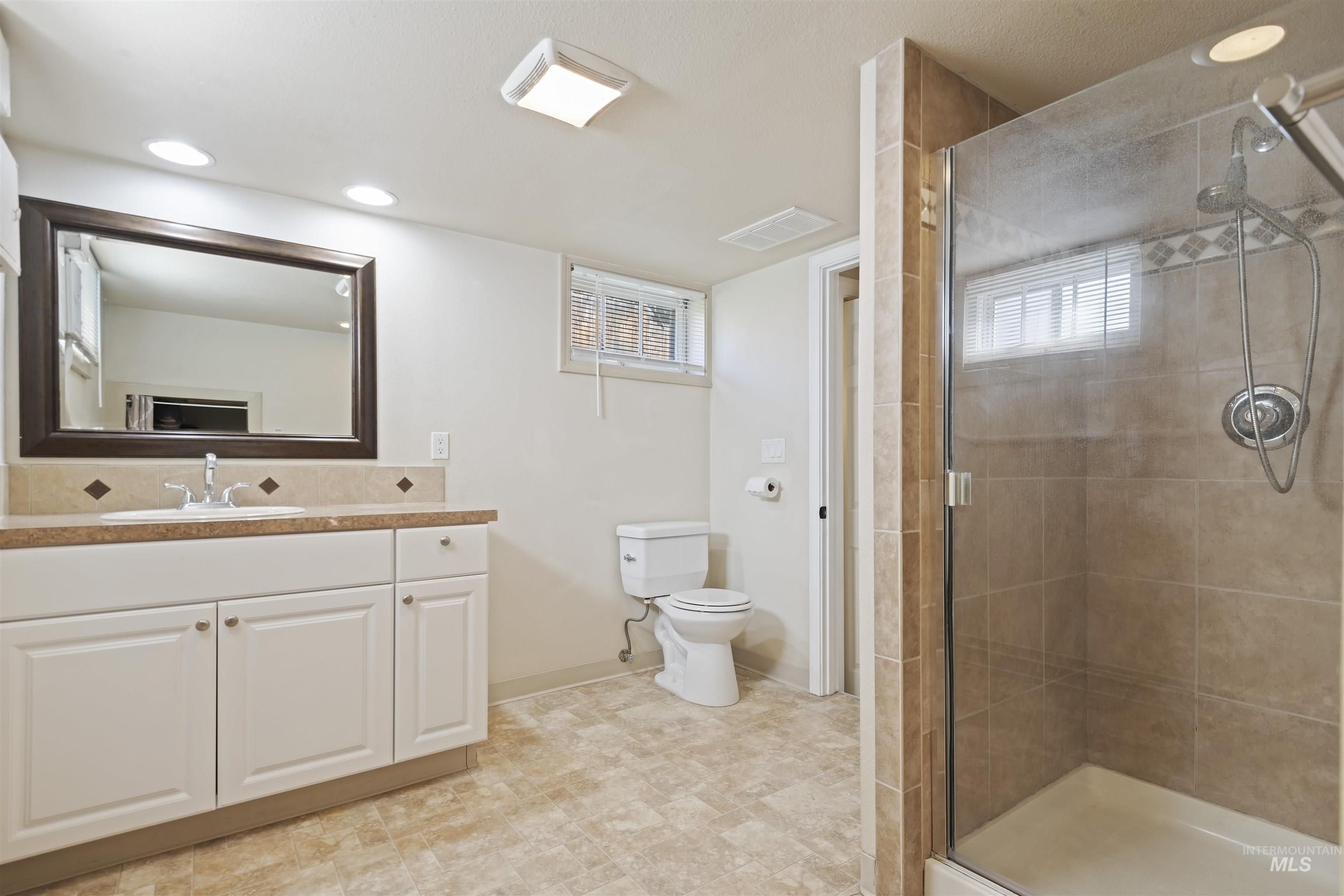 1803 South Arcadia Street Boise, ID 83705 - Photo 22 of 30 Bathroom with vanity, a shower stall, and recessed lighting