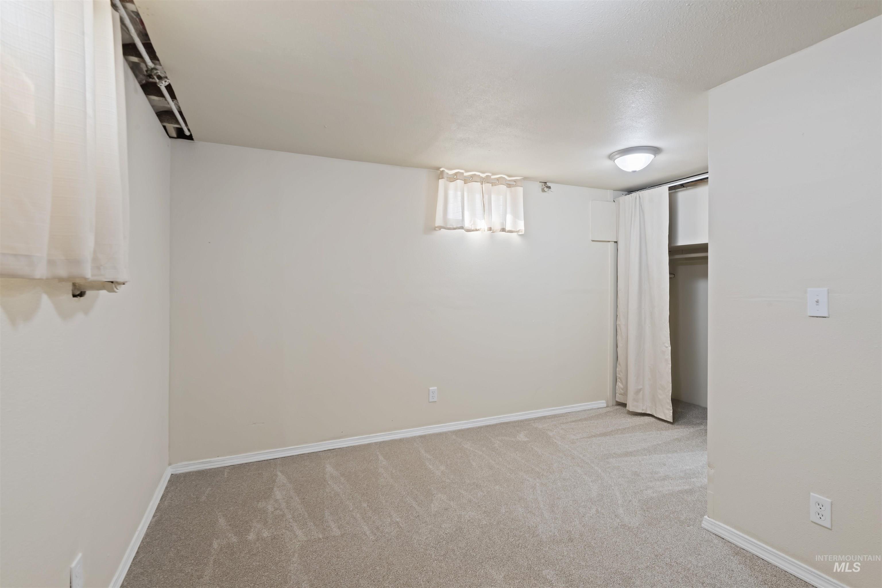 1803 South Arcadia Street Boise, ID 83705 - Photo 25 of 30 Below grade area with light colored carpet and baseboards