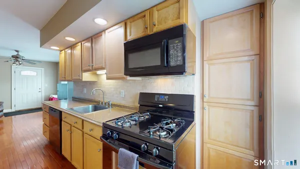 a kitchen with stainless steel appliances granite countertop a stove and a microwave