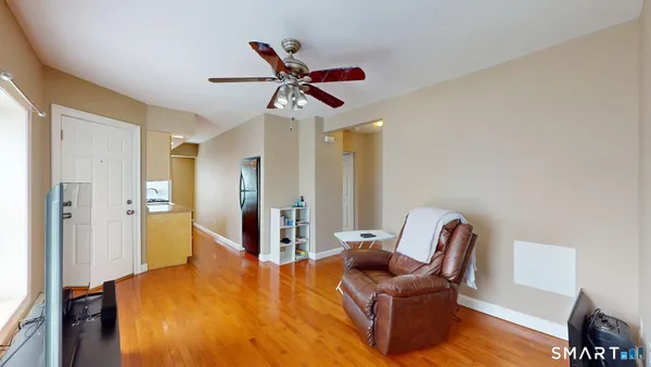 a view of a livingroom with furniture and a ceiling fan