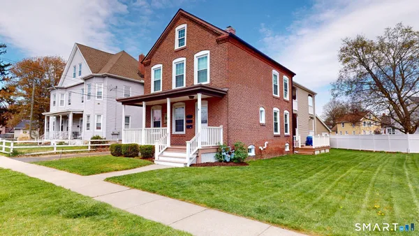 a front view of house with yard and green space