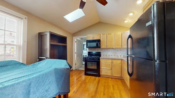a kitchen with a refrigerator and a stove top oven