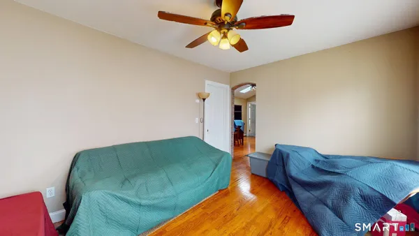 a living room with a bed furniture and a chandelier